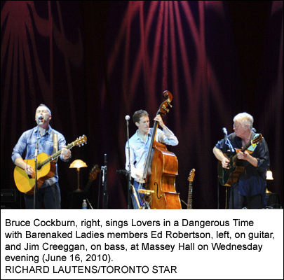 Bruce Cockburn, right, sings Lovers in a Dangerous Time with Barenaked Ladies members Ed Robertson, left, on guitar, and Jim Creeggan, on bass, at Massey Hall on Wednesday evening June 16, 2010 - Photo: RICHARD LAUTENS/TORONTO STAR