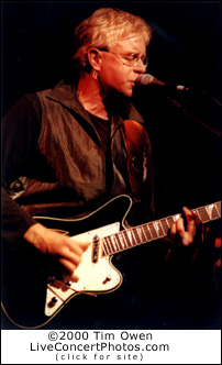  Bruce Cockburn playing guitar on stage at the Verde Valley Festival, Sedona, AZ - 10/4/98. Photo by Tim Owen
