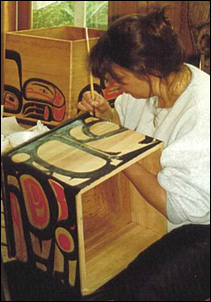 Sylvia Young from Skidegate, painting bent wood boxes.